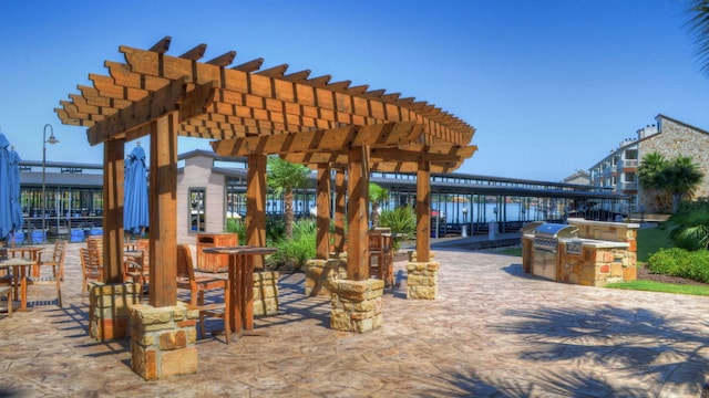 101 W Bank Unit 51, Horseshoe Bay, TX 78657 - view of patio / terrace featuring an outdoor kitchen and a pergola