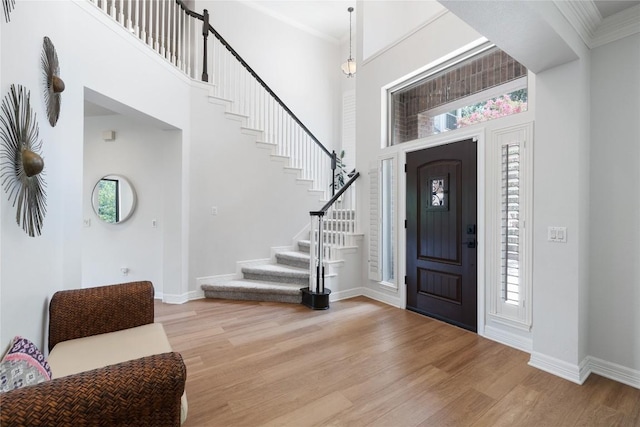 10636 Bramblecrest Dr, Austin, TX 78726 - foyer entrance with light wood-style floors, stairs, healthy amount of natural light, crown molding, and a high ceiling