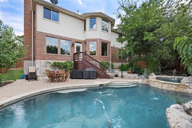 10636 Bramblecrest Dr, Austin, TX 78726 - rear view of property featuring brick siding, a patio area, and a pool with connected hot tub