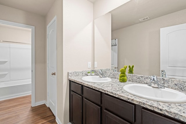 1698 Violet Ln, Kyle, TX 78640 - full bath with double vanity and wood finished floors
