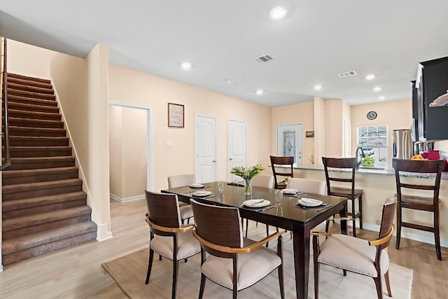 1698 Violet Ln, Kyle, TX 78640 - dining area with stairway, light wood-style floors, and recessed lighting