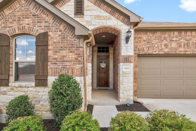 1520 Beard Pass, Leander, TX 78641 - doorway to property with a garage, brick siding, driveway, and stone siding
