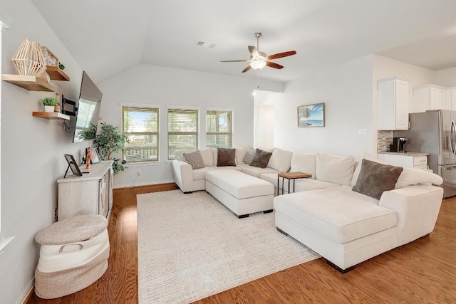 1520 Beard Pass, Leander, TX 78641 - living room featuring a ceiling fan, light wood-type flooring, and vaulted ceiling