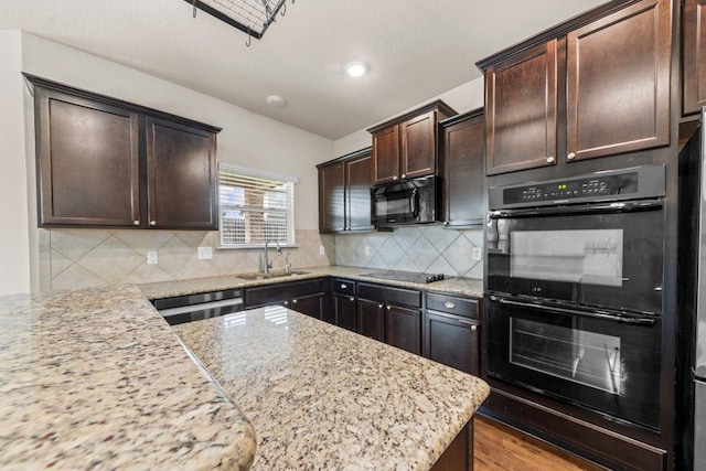 3303 Lorne Dr, Killeen, TX 76542 - kitchen with black appliances, dark brown cabinetry, light stone countertops, tasteful backsplash, and wood finished floors