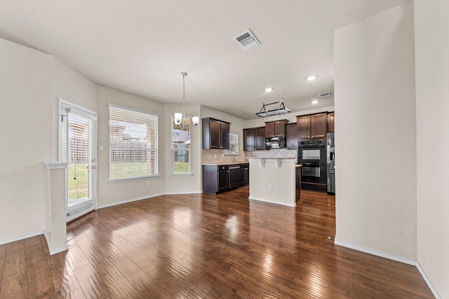 3303 Lorne Dr, Killeen, TX 76542 - kitchen with black appliances, a chandelier, light countertops, a kitchen island, and dark brown cabinets