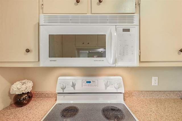230 Lido St Unit I-2, Lakeway, TX 78734 - kitchen view of white microwave, range, and light countertops