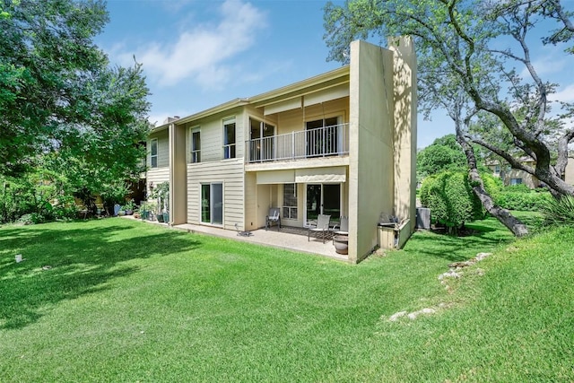 230 Lido St Unit I-2, Lakeway, TX 78734 - rear view of property featuring a balcony, a patio, a yard, and a chimney