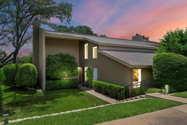 230 Lido St Unit I-2, Lakeway, TX 78734 - view of front of home featuring a front lawn, a shingled roof, and stucco siding