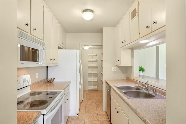 230 Lido St Unit I-2, Lakeway, TX 78734 - kitchen featuring white appliances, light countertops, light tile patterned floors, and white cabinets