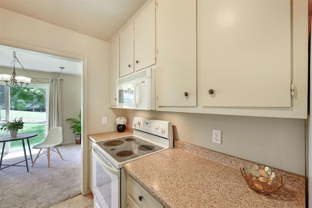230 Lido St Unit I-2, Lakeway, TX 78734 - kitchen featuring white appliances, light countertops, light carpet, a chandelier, and white cabinetry