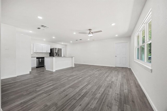 605 W Washington Ave, Copperas Cove, TX 76522 - unfurnished living room with dark wood-style flooring, a ceiling fan, and recessed lighting