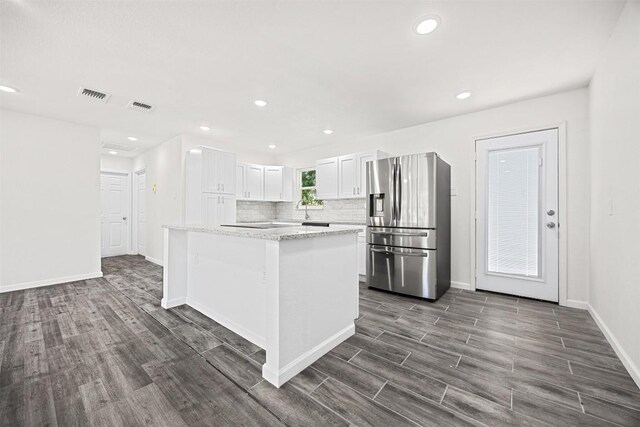 605 W Washington Ave, Copperas Cove, TX 76522 - kitchen with stainless steel refrigerator with ice dispenser, dark wood-style floors, white cabinetry, backsplash, and recessed lighting