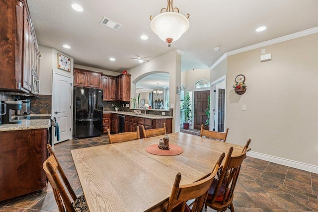 2010 American Dr Unit 2, Lago Vista, TX 78645 - dining room with arched walkways, recessed lighting, a chandelier, ornamental molding, and dark stone finish flooring