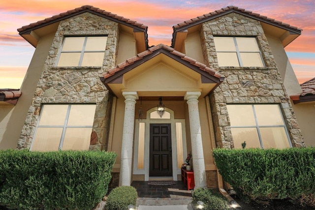2010 American Dr Unit 2, Lago Vista, TX 78645 - view of front of house with stone siding, a tile roof, and stucco siding