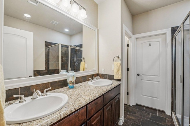 2010 American Dr Unit 2, Lago Vista, TX 78645 - bathroom featuring a stall shower, double vanity, and stone finish floors