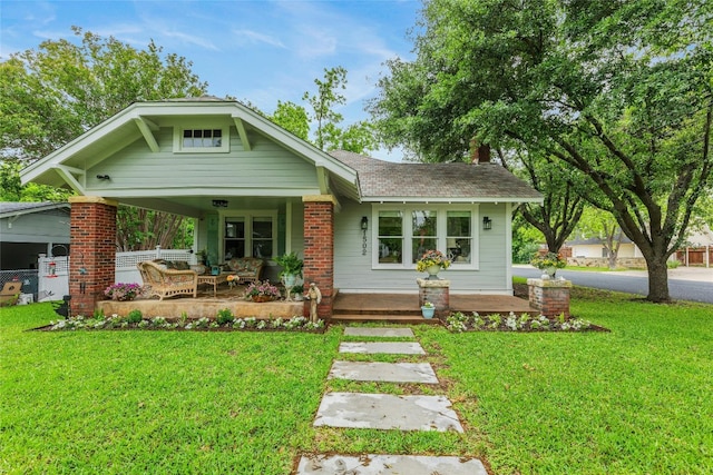 1502 Olive St, Georgetown, TX 78626 - view of front facade with a front lawn, an outdoor living space, covered porch, and a shingled roof