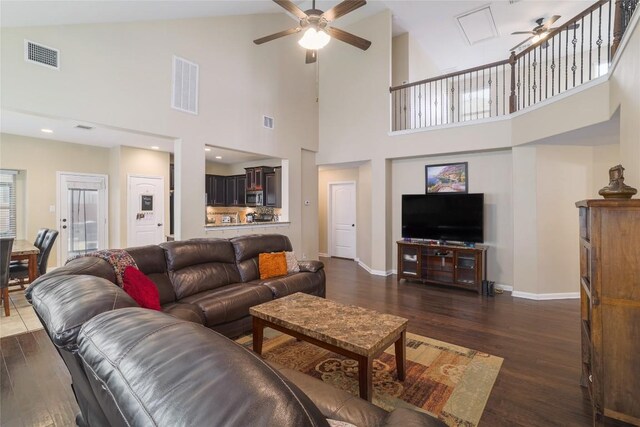 2524 Muzzie Ln, Leander, TX 78641 - living room featuring a ceiling fan, a high ceiling, and dark wood finished floors