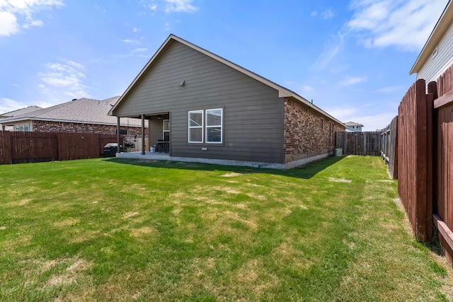 19021 Quebrada Dr, Pflugerville, TX 78660 - rear view of property with a fenced backyard, a patio, and brick siding
