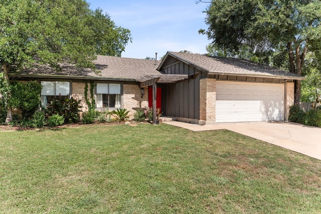 4903 Big Trail Cir, Austin, TX 78759 - view of front of property featuring board and batten siding, a garage, driveway, a front lawn, and roof with shingles