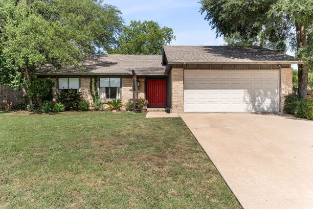 4903 Big Trail Cir, Austin, TX 78759 - view of front facade featuring concrete driveway, an attached garage, a front yard, and brick siding