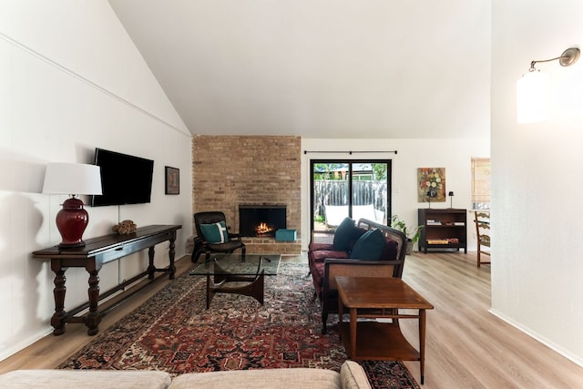 4903 Big Trail Cir, Austin, TX 78759 - living area featuring high vaulted ceiling, wood finished floors, and a brick fireplace