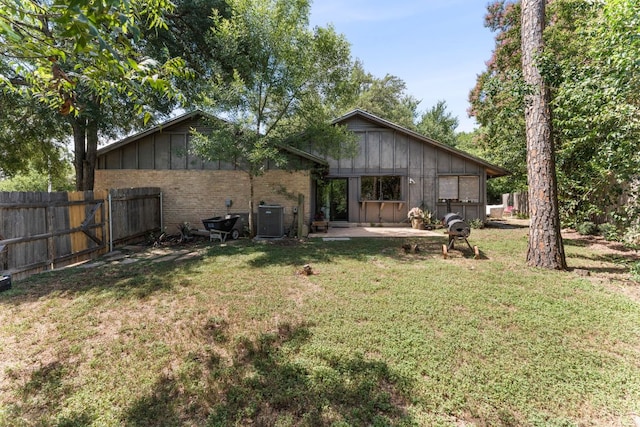 4903 Big Trail Cir, Austin, TX 78759 - rear view of property with board and batten siding, a patio, and brick siding