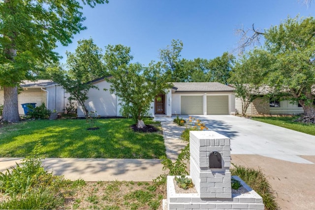 2515 Mcgregor Dr, Austin, TX 78745 - view of front of house featuring concrete driveway, an attached garage, and a front yard