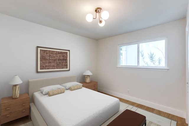 2515 Mcgregor Dr, Austin, TX 78745 - bedroom with light wood finished floors and a chandelier