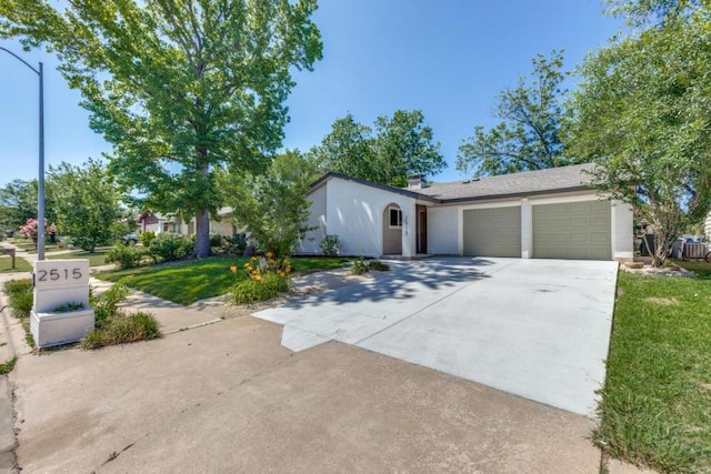 2515 Mcgregor Dr, Austin, TX 78745 - view of front of property featuring an attached garage, concrete driveway, a front yard, a chimney, and stucco siding