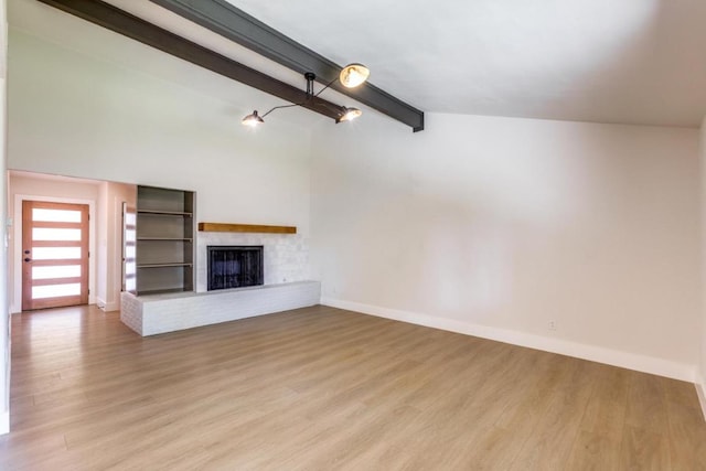 2515 Mcgregor Dr, Austin, TX 78745 - unfurnished living room featuring light wood-style flooring and a brick fireplace