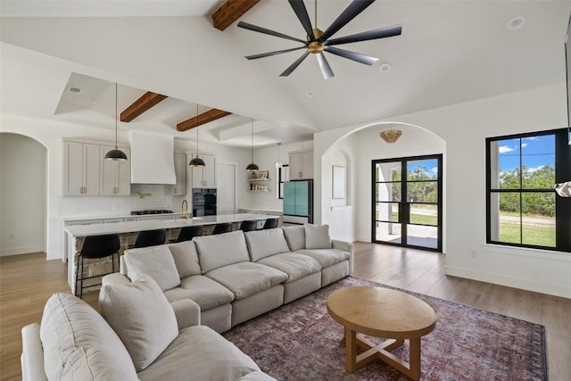 1129 Madrone Rd, Fischer, TX 78623 - living area with arched walkways, a ceiling fan, and light wood-type flooring