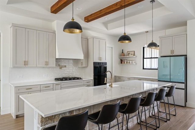 1129 Madrone Rd, Fischer, TX 78623 - kitchen with freestanding refrigerator, open shelves, gas cooktop, light wood-type flooring, and beamed ceiling