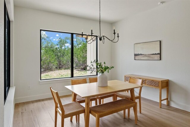 1129 Madrone Rd, Fischer, TX 78623 - dining room featuring plenty of natural light, light wood-type flooring, and a chandelier