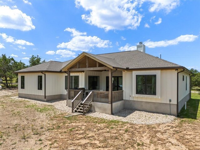 1129 Madrone Rd, Fischer, TX 78623 - rear view of house featuring a chimney, a shingled roof, board and batten siding, and a porch