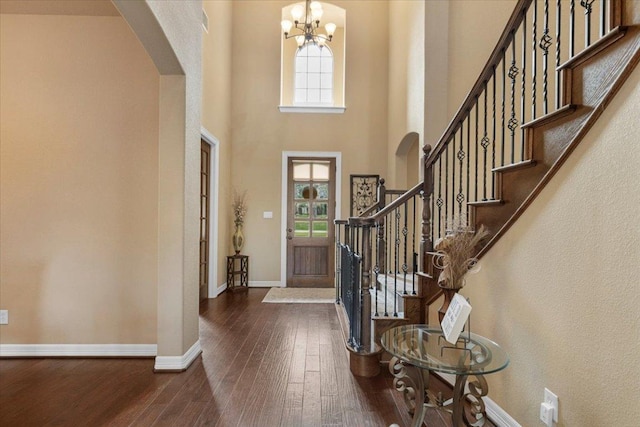 2308 First Vw, Leander, TX 78641 - foyer with arched walkways, wood-type flooring, a chandelier, stairway, and a high ceiling