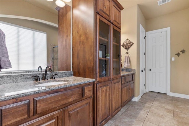 2308 First Vw, Leander, TX 78641 - bathroom with double vanity, tile patterned floors, and a shower with door