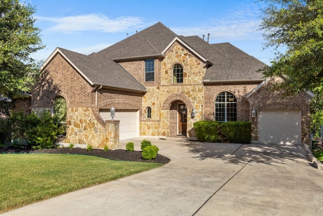 2308 First Vw, Leander, TX 78641 - french provincial home featuring concrete driveway, a garage, and a shingled roof