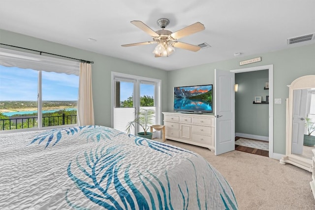18917 Peckham Dr, Point Venture, TX 78645 - carpeted bedroom with access to exterior, ceiling fan, and a water view
