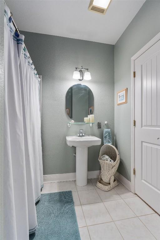 18917 Peckham Dr, Point Venture, TX 78645 - full bathroom with tile patterned flooring and baseboards