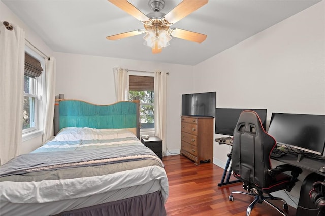 18917 Peckham Dr, Point Venture, TX 78645 - bedroom with wood finished floors, a desk, and a ceiling fan