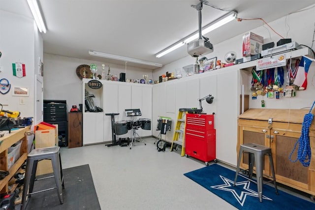 18917 Peckham Dr, Point Venture, TX 78645 - garage featuring a workshop area and a garage door opener