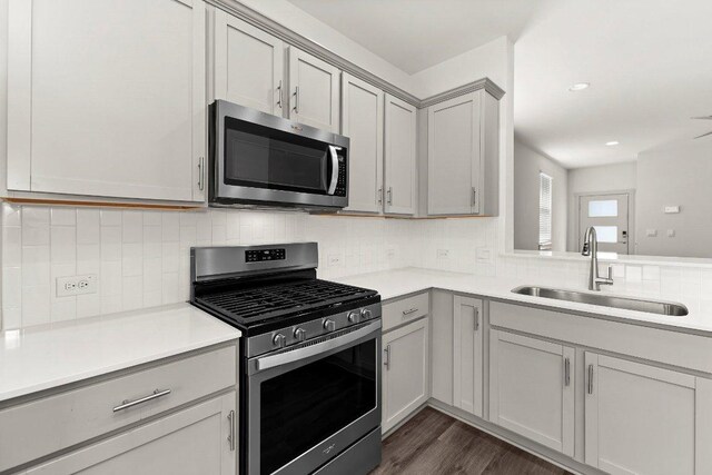7707 Jackson Graham Dr, Austin, TX 78724 - kitchen featuring appliances with stainless steel finishes, gray cabinetry, light countertops, and recessed lighting
