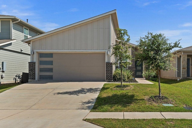 7707 Jackson Graham Dr, Austin, TX 78724 - view of front of house featuring board and batten siding, a garage, concrete driveway, a front lawn, and brick siding