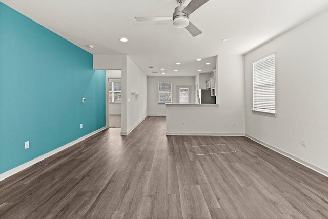 7707 Jackson Graham Dr, Austin, TX 78724 - unfurnished living room featuring a ceiling fan, dark wood-style floors, and recessed lighting