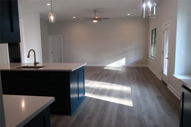 126 E Pauwela Ln, Bastrop, TX 78602 - kitchen with light countertops, ceiling fan, wood finished floors, hanging light fixtures, and recessed lighting