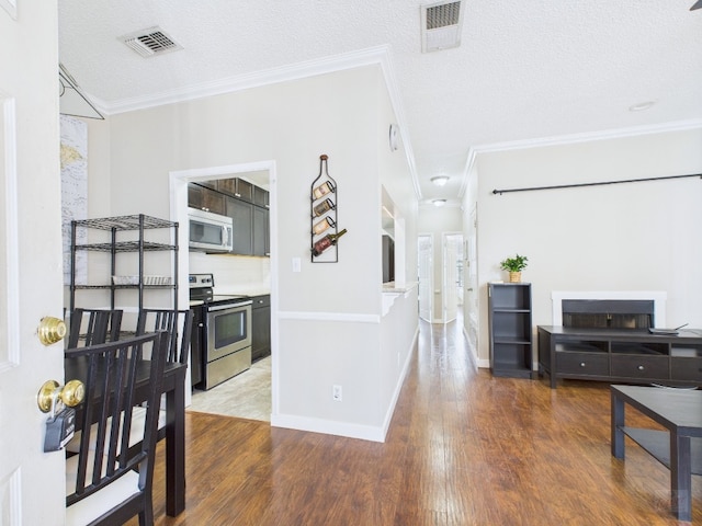 2300 Leon St Unit 205, Austin, TX 78705 - hall with ornamental molding, wood finished floors, and a textured ceiling