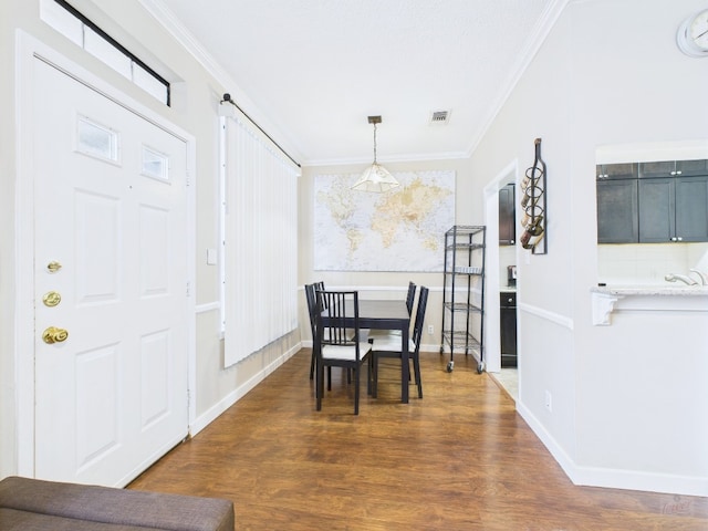 2300 Leon St Unit 205, Austin, TX 78705 - dining area with crown molding and dark wood-style flooring