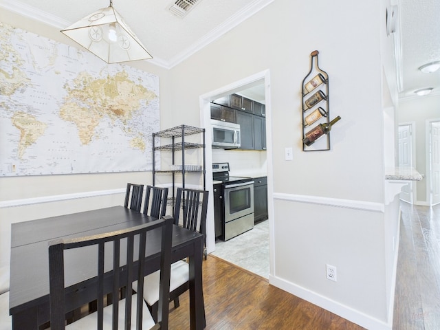 2300 Leon St Unit 205, Austin, TX 78705 - unfurnished dining area featuring ornamental molding and wood finished floors