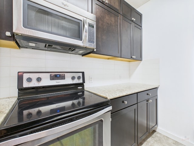 2300 Leon St Unit 205, Austin, TX 78705 - kitchen with stainless steel appliances, decorative backsplash, light stone countertops, and dark brown cabinetry