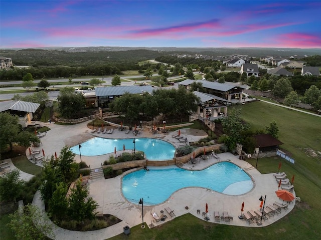 202 Hazy Hills Loop, Dripping Springs, TX 78620 - pool at dusk featuring a community pool and a patio